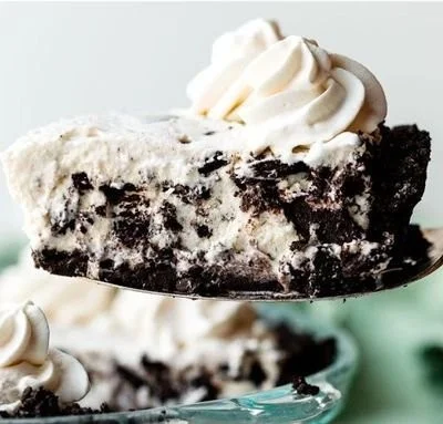 Delicious slice of Cookies and Cream Pie with cookie crust and creamy filling