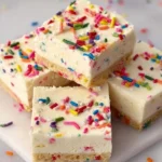 No-bake Funfetti cheesecake bars topped with colorful sprinkles