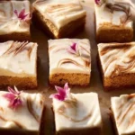 Delicious carrot cake cheesecake bars topped with cream cheese frosting.