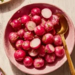 Plate of miso-glazed radishes garnished with herbs.