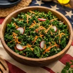A vibrant bowl of Kale and Carrot Slaw topped with dressing, showcasing fresh ingredients.